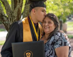 Graduate kissing a family member